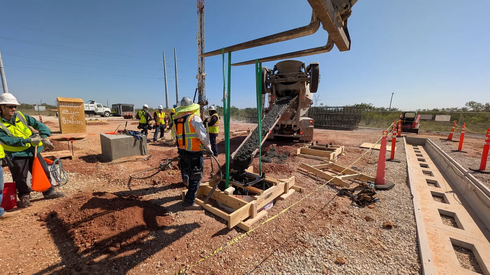 Crew placing concrete for a drilled pier from a mixer chute