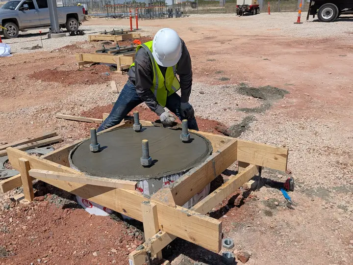 Worker finishing the top of a concrete pier cap