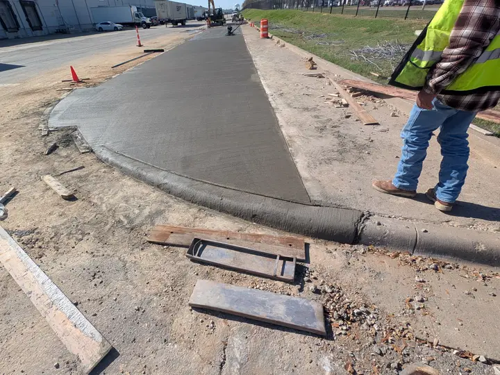 New curb, gutter, and walkway pour along a road