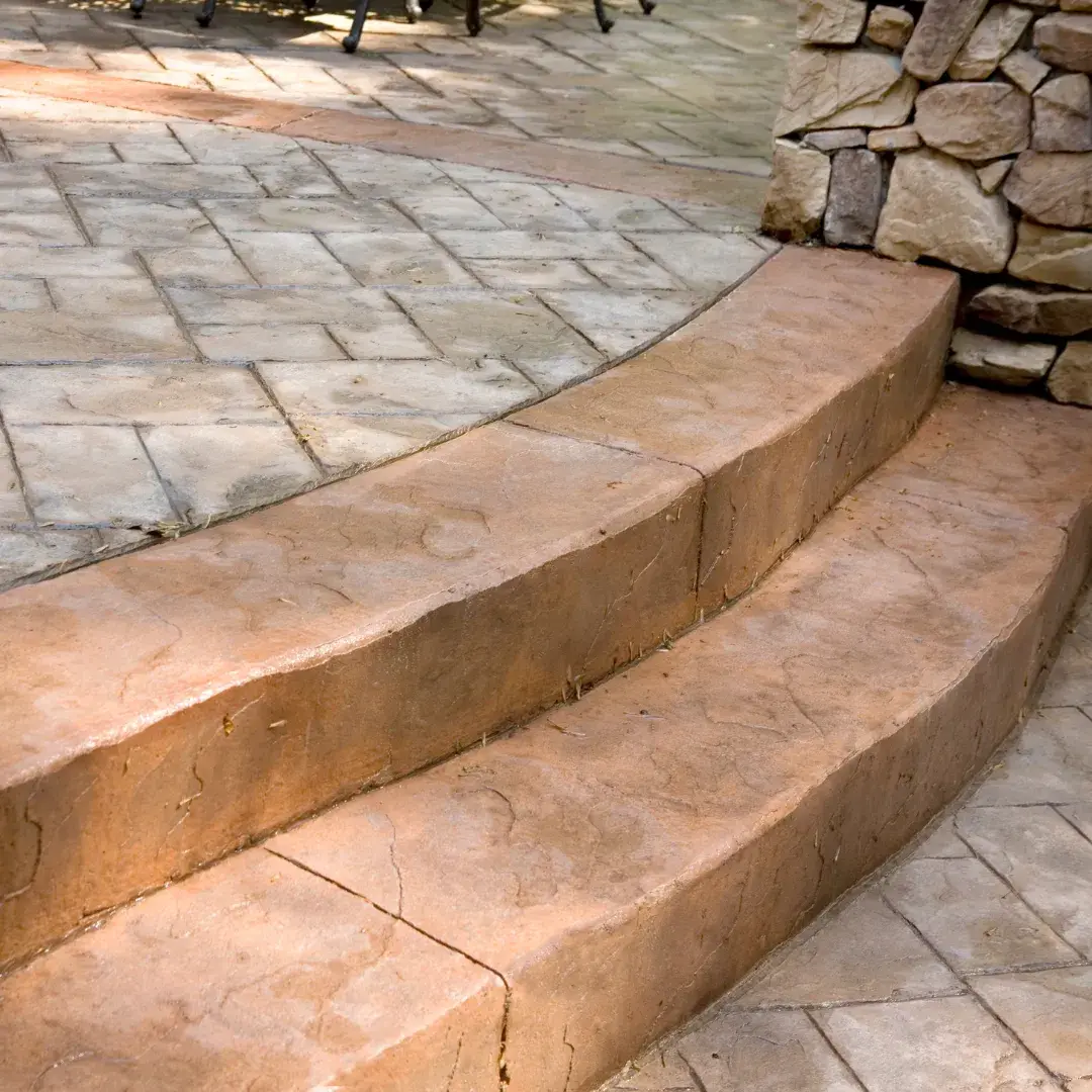Stamped concrete steps and patio with stone wall